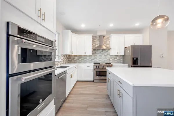 a kitchen with a sink stove and refrigerator