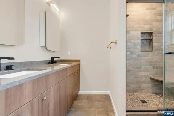 a bathroom with a double vanity sink and a mirror