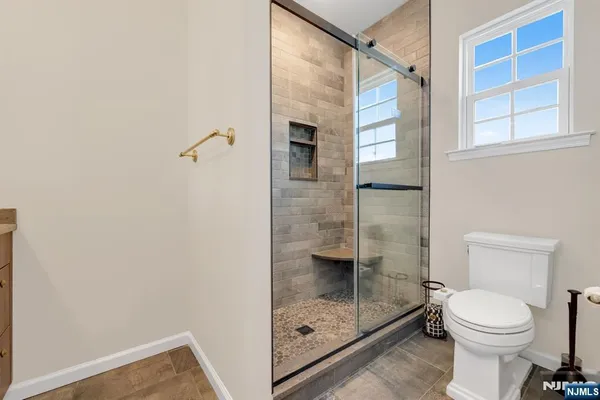 a bathroom with a shower and a toilet