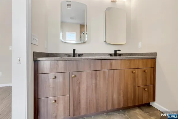 a bathroom with a double vanity sink and mirror