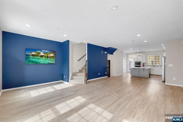 a view of a livingroom with furniture and a kitchen
