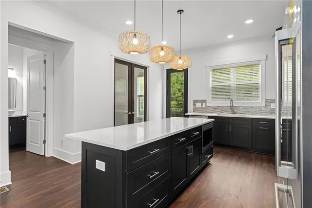 a kitchen with a sink stove and cabinets