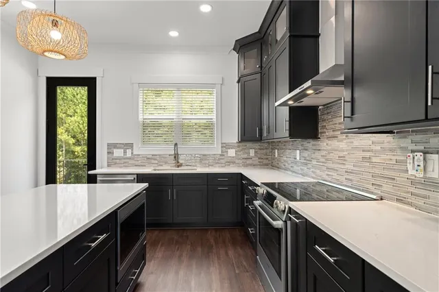 a large kitchen with granite countertop a stove and a sink