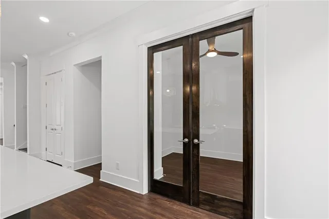a view of a hallway with wooden floor