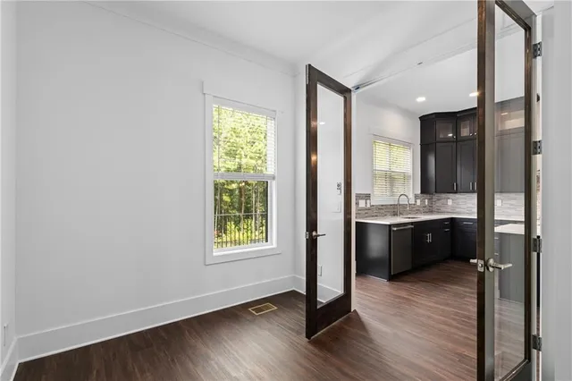 a view of a hallway with wooden floor and closet area