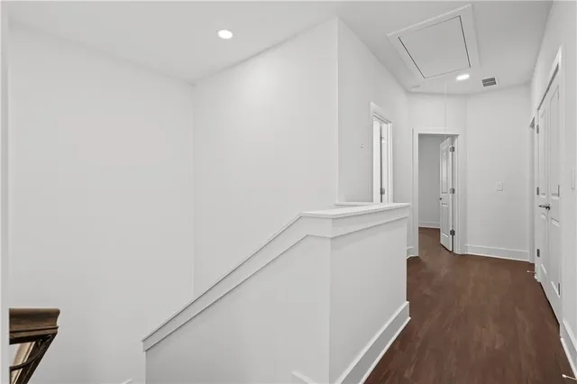 an empty room with wooden floor and window