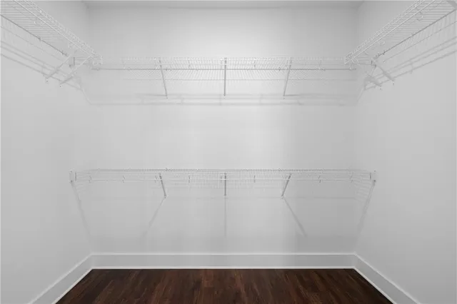 a bathroom with a tub a sink and a large mirror