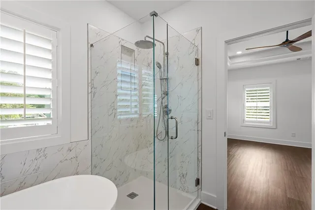 a bathroom with a granite countertop sink toilet and mirror