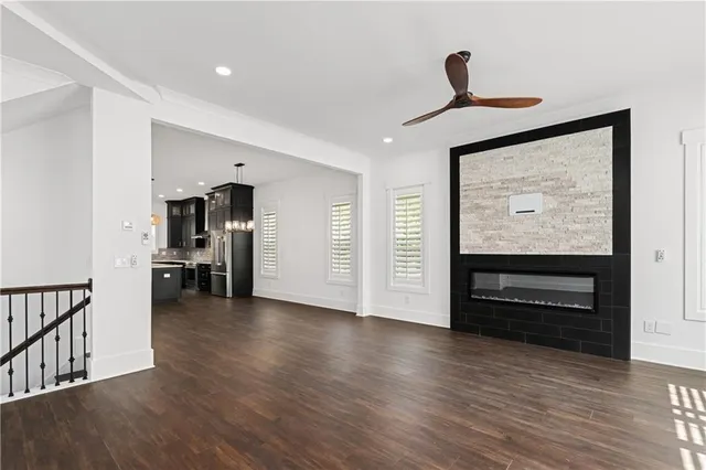 a view of empty room with wooden floor and window