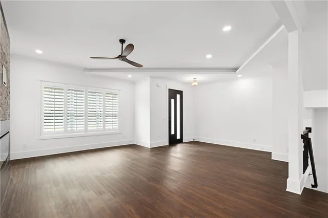 a view of a kitchen with stainless steel appliances granite countertop a stove a refrigerator a sink dishwasher and a oven with wooden floor