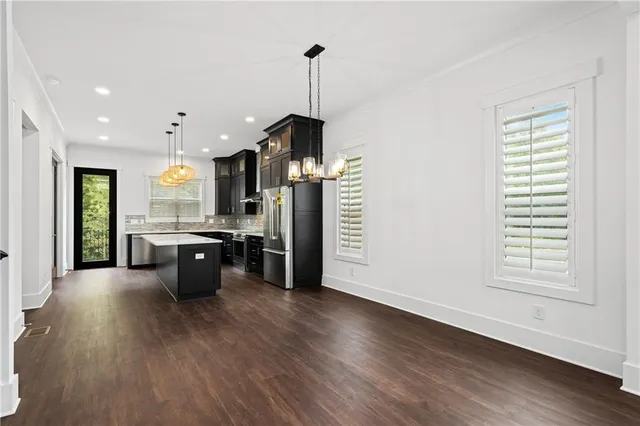 a view of a room with wooden floor staircase and windows