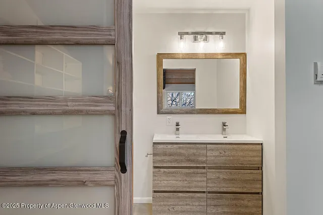 a bathroom with a sink and a mirror