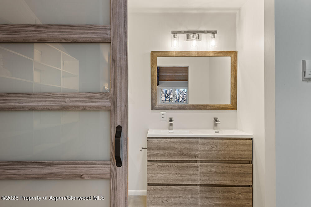 1215 Riverside Drive Aspen, CO 81611 - Photo 15 of 20 a bathroom with a sink and a mirror