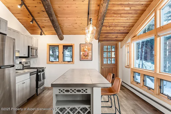 a open kitchen with stainless steel appliances granite countertop a stove and a refrigerator