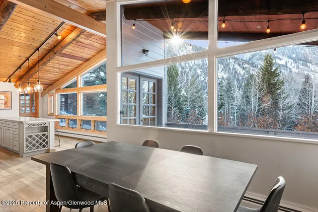 a view of a dining room with furniture window and outside view