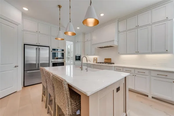 a kitchen with a refrigerator a sink and cabinets
