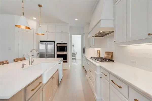 a kitchen with a sink stove and refrigerator