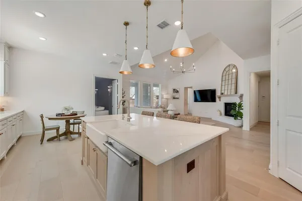 a large kitchen with a table and chairs