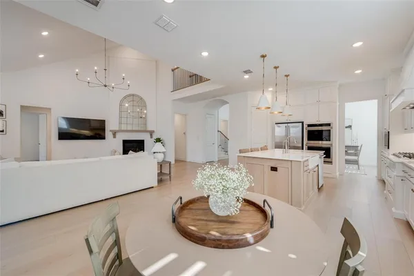a living room with furniture kitchen and a table