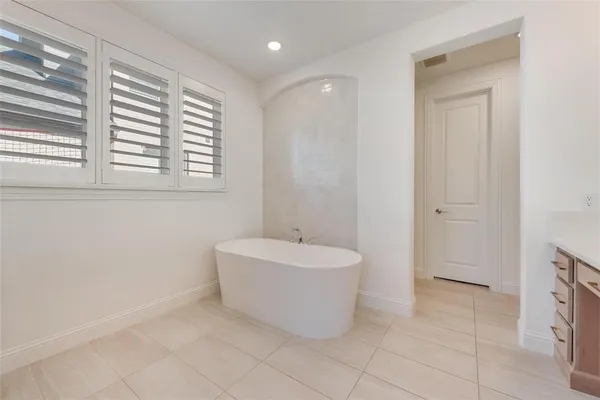 a bathroom with a bathtub and a sink