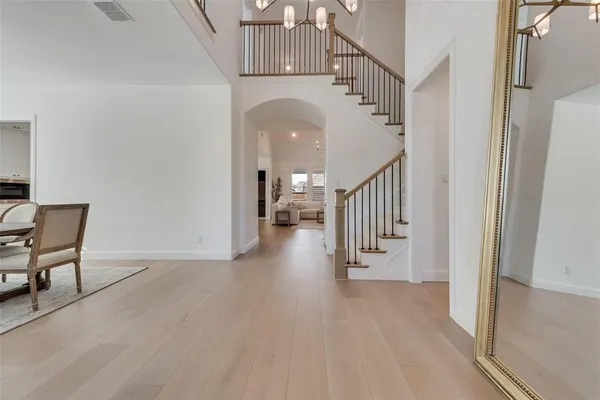 a view of a hallway with entryway wooden floor and front door