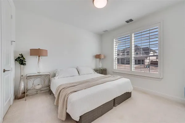 a bedroom with a bed potted plant with the window
