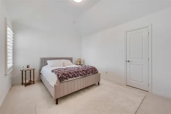 a bedroom with a bed and a night lamp