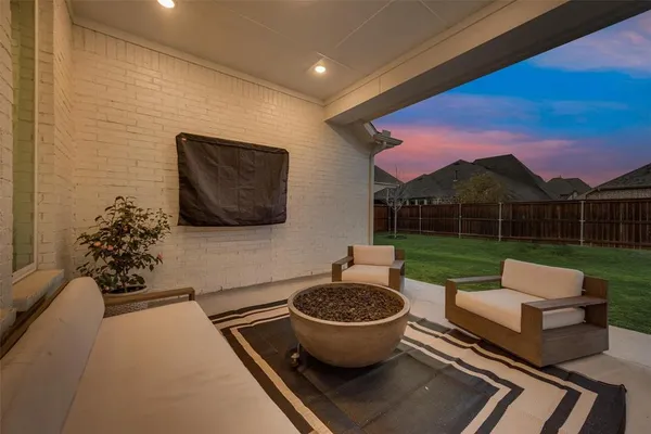 a view of a chairs and table in backyard