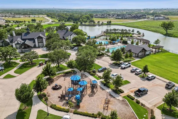 an aerial view of lake residential house with swimming pool and outdoor space