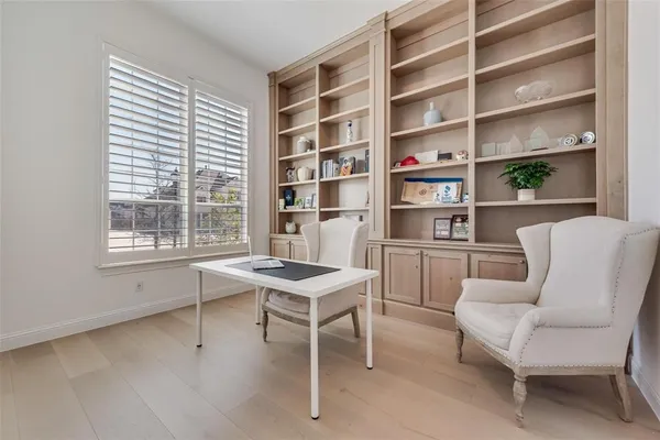 a work room with furniture and a book shelf