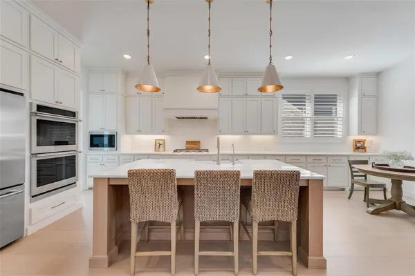 a kitchen with granite countertop counter space a sink a center island stainless steel appliances and cabinets