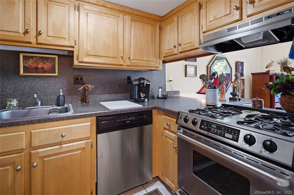 a kitchen with stainless steel appliances granite countertop a stove and a microwave