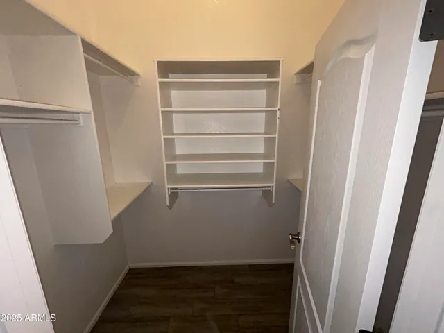 a view of walk in closet with empty racks