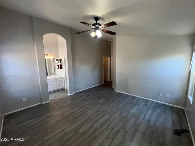 a view of a livingroom with a hardwood floor and a ceiling fan