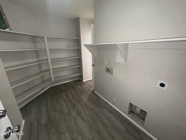 a view of walk in closet with empty racks