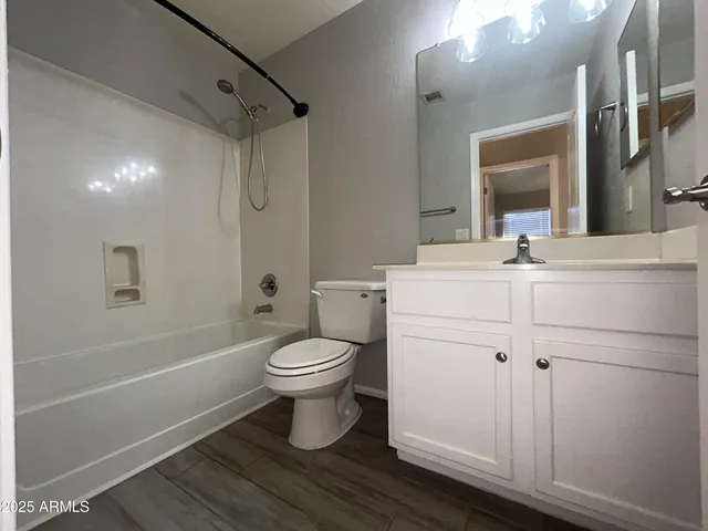 a bathroom with a toilet sink a mirror and shower