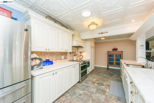 a large white kitchen with a large window