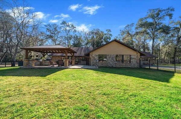 a living room with furniture a fireplace and a chandelier