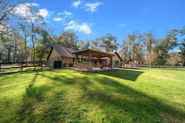 a large kitchen with stainless steel appliances granite countertop a lot of counter space
