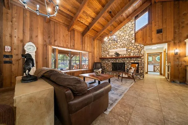 a living room with furniture a flat screen tv and a table