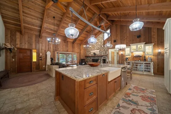 a view of a house that has a big tree with wooden fence
