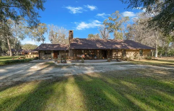 a view of a house with a yard and sitting area
