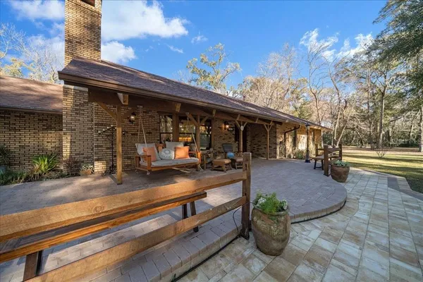 a view of house with swimming pool yard and outdoor seating