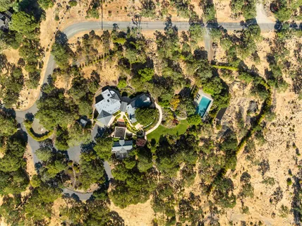 a view of a house with garden and lawn chairs