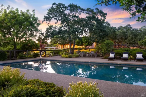 a view of a house with a garden and a mountain view