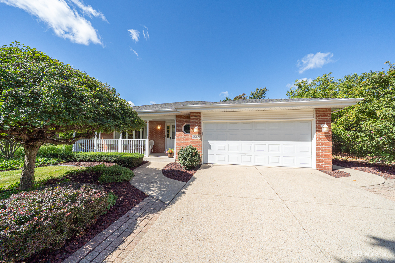 a view of a house with a yard and potted plants