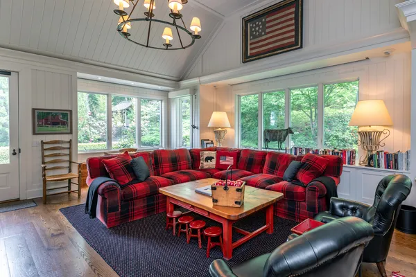 a living room with furniture a table and a large window
