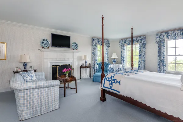 a bed room with furniture and a fireplace