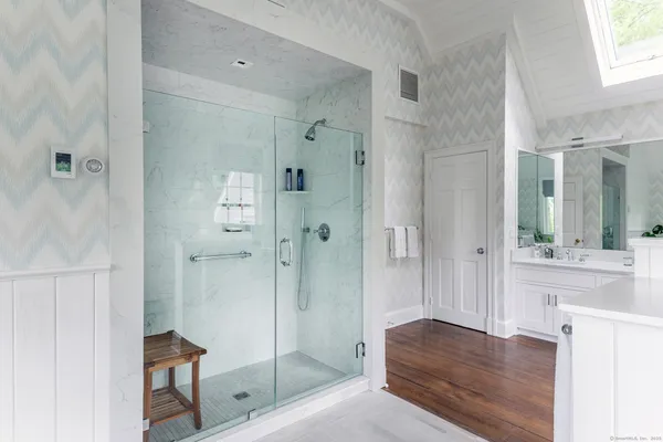 a bathroom with a shower and a sink