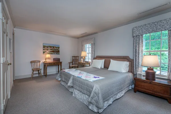 a bedroom with a bed and a lamp on table